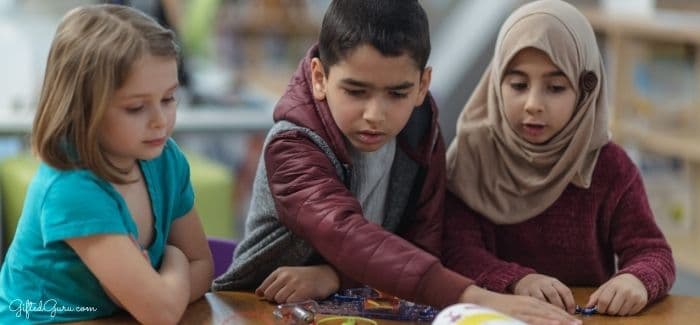 three children looking at a book