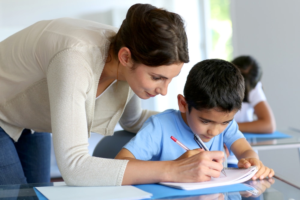 teacher working with student