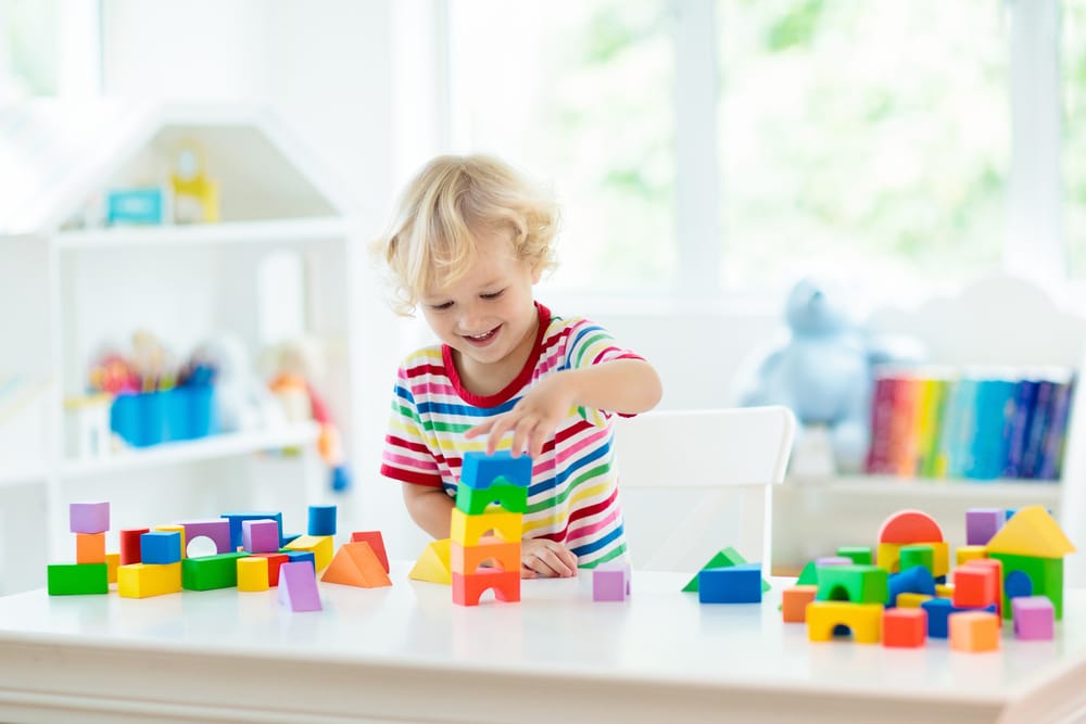small boy playing with blocks 
