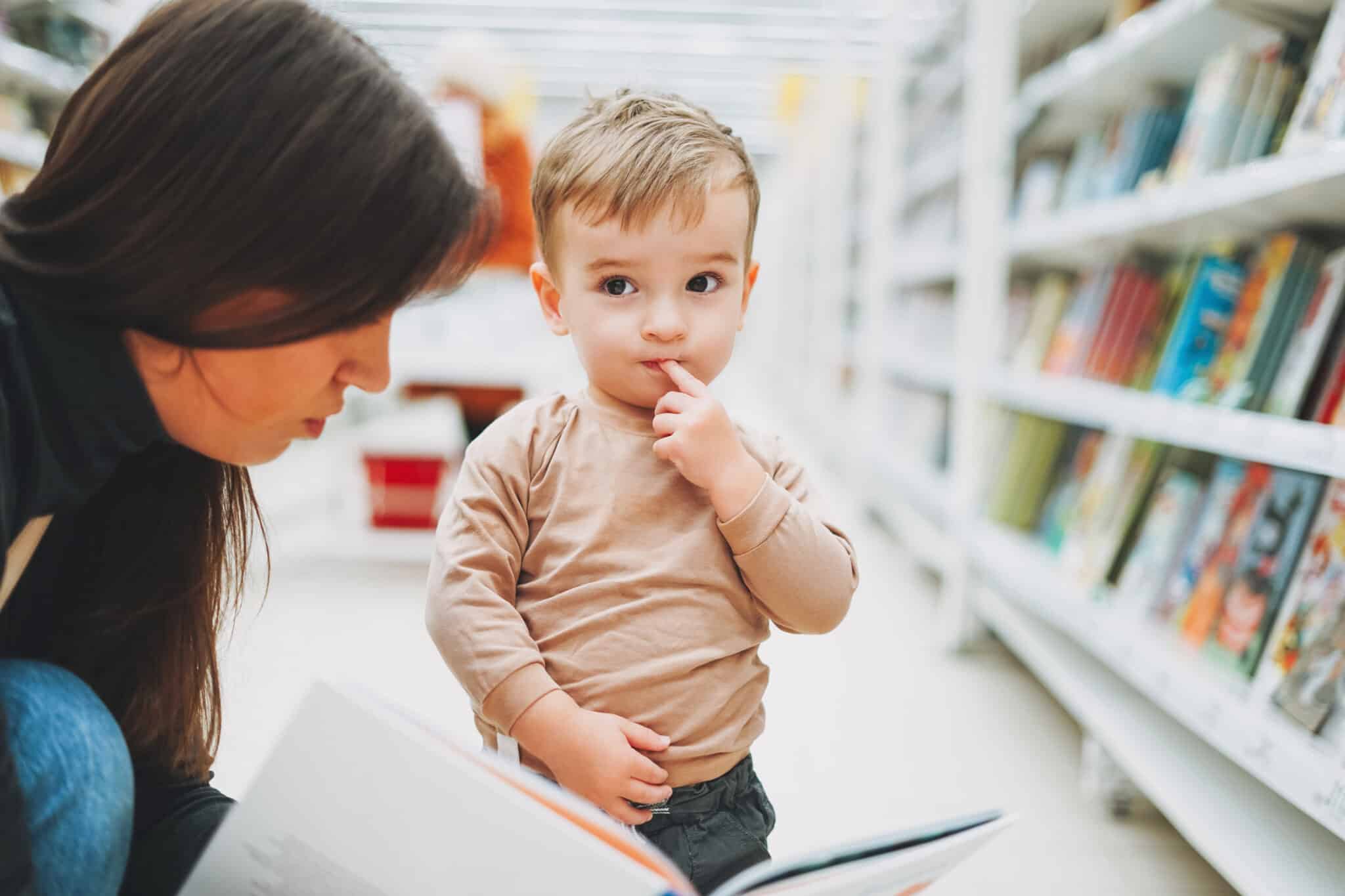 mother and child in book store looking at book